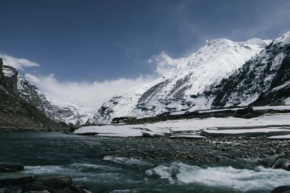 Glacier-fed Himalayan river flowing through mountain valleys and communities