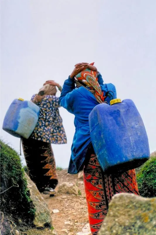 Women collecting water in a Himalayan village facing water shortage due to climate change