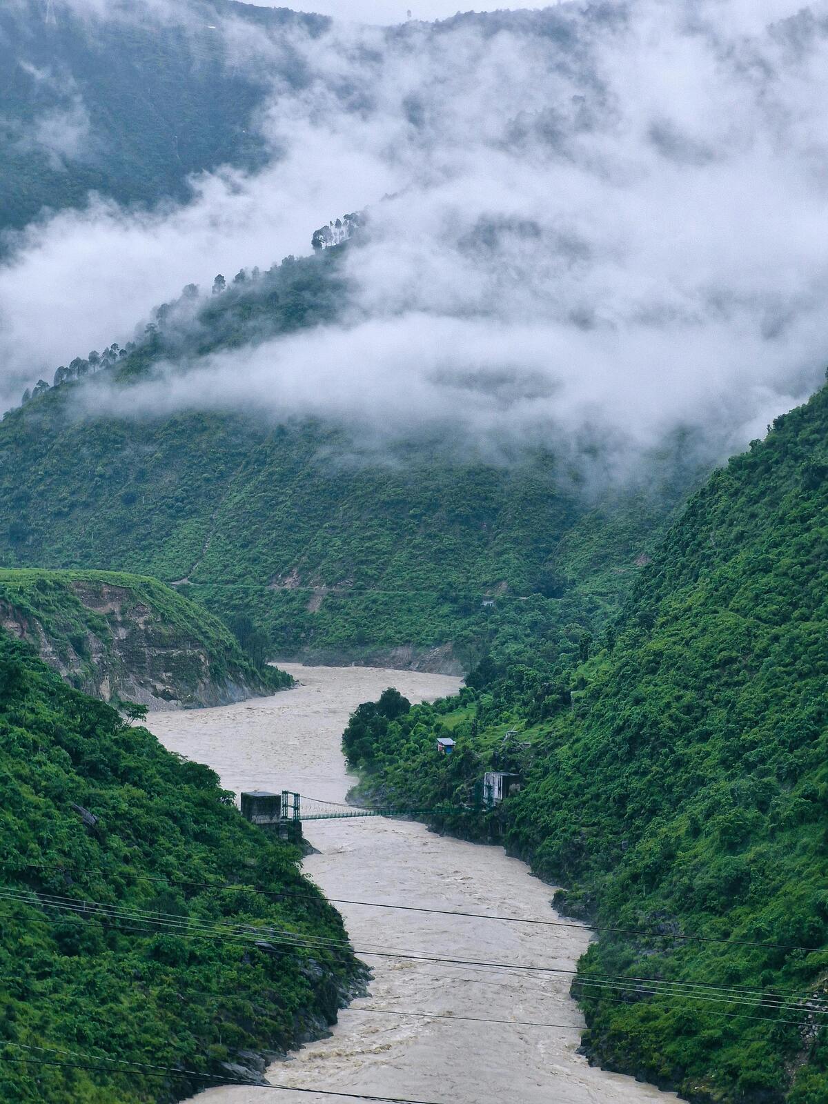 Flash flood waters rushing through a Himalayan valley in Uttarakhand during monsoon