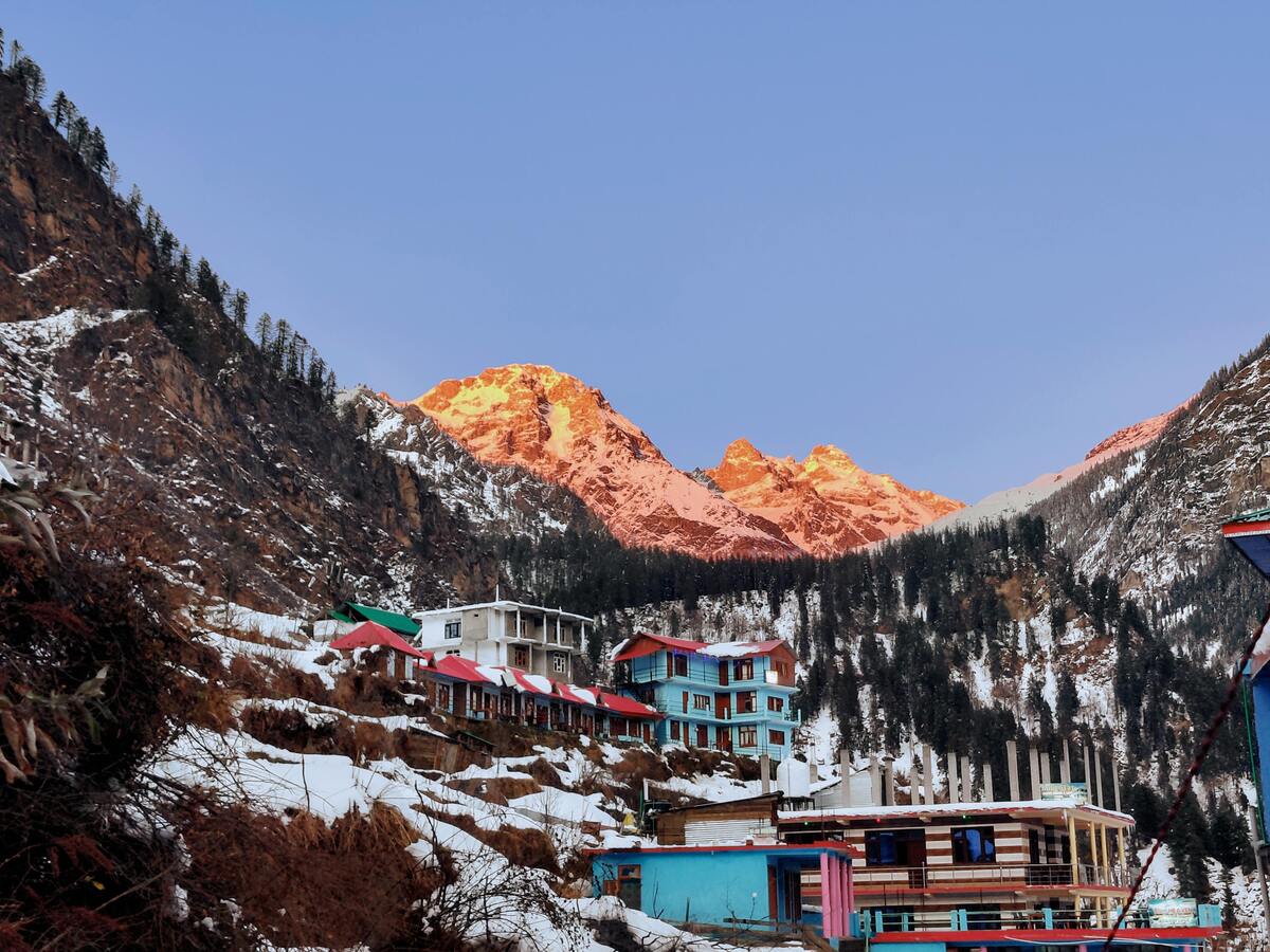 A locally run homestay in a Himalayan village surrounded by mountains, reflecting responsible and community-based tourism